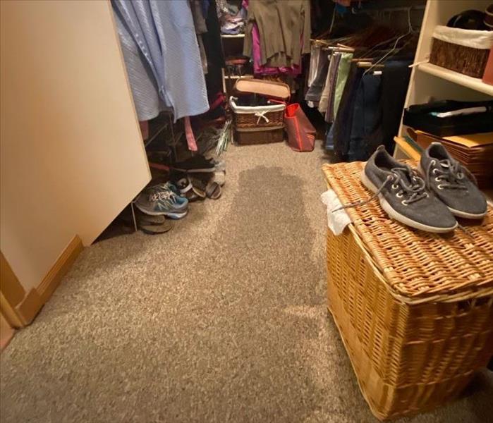 closet with water stain on the carpet