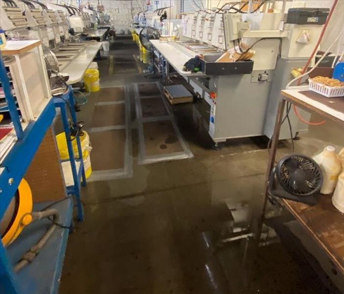 warehouse with water puddle on the floor in-between machines