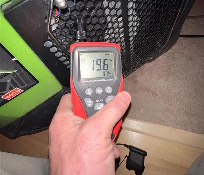 SERPVRO Employee reading meter in home after water damage