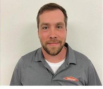 Male employee Zach Broome with a SERVPRO polo on a white background.